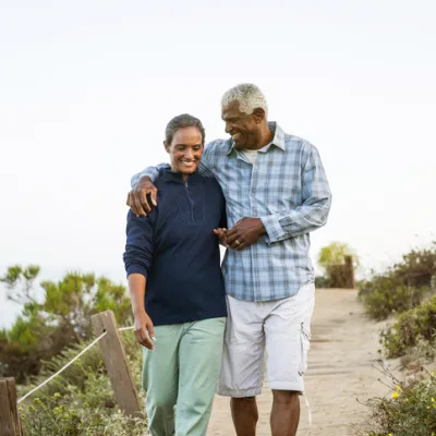 Husband and wife walking on beach