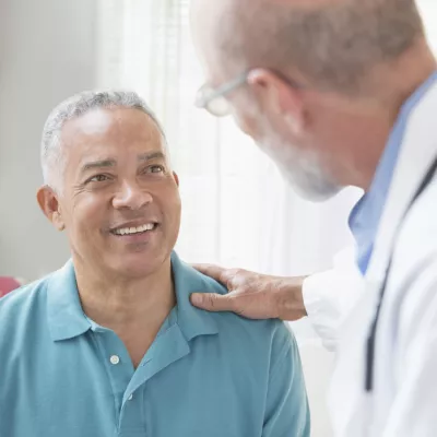Blue Shirt Hispanic Man with Caucasian Doctor