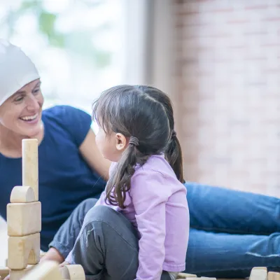 female brain cancer patient interacting with female child