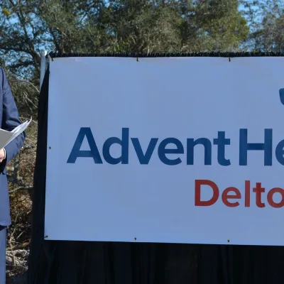 A speech being conducted outdoors for Deltona's emergency room building