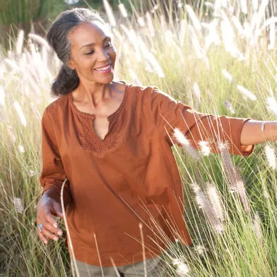 A woman outdoors in a field. 