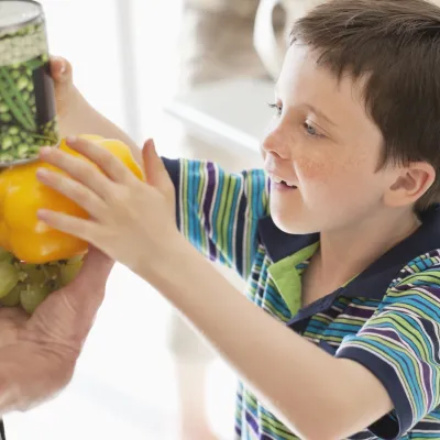 A boy discovering new types of vegetables. 