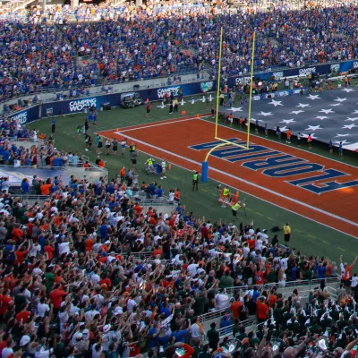 In the stands, looking over as the American flag is stretched over the field at Camping World Stadium.