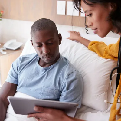 Young man discusses his care with a provider