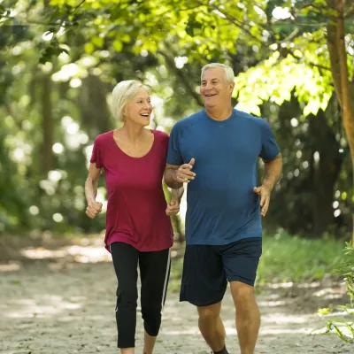 Older couple Jogging through the woods