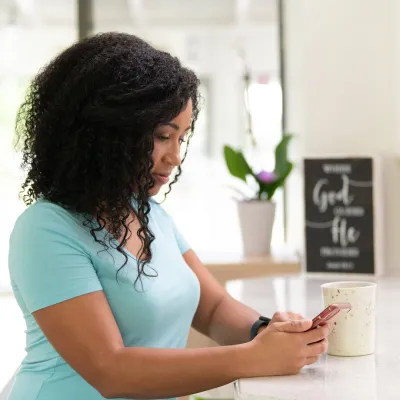 Woman at home on phone side profile serious