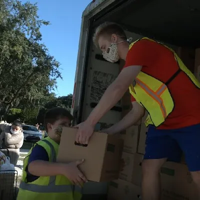Volunteers unload a truck of food at the Hope Center