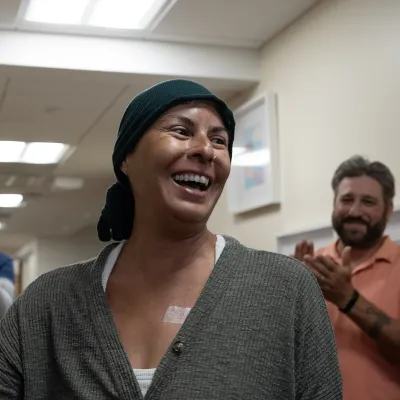 Smiling patient ringing a bell