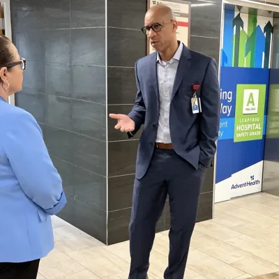 Lorenzo Brown talks with Deltona City Commissioner Avila-Vazquez in the lobby of AdventHealth Fish Memorial.