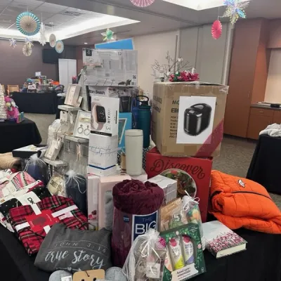 Photo shows piles of presents on a table at the Parker Christmas Store