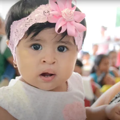 a baby being held by a woman
