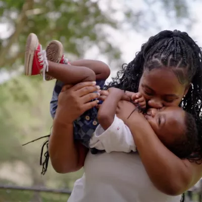 A woman holding her young son.