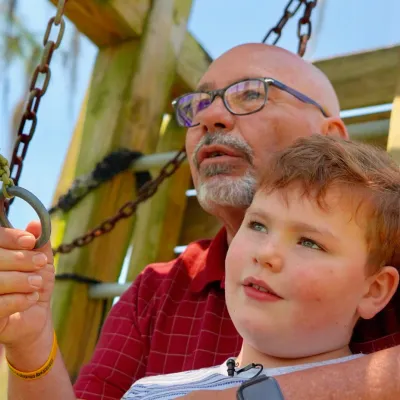 Jeff and Noah Thompson playing a game outside together.