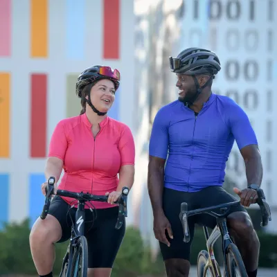 A man and woman taking a break during a bike ride.