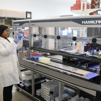 Female Laboratory Team Member Using Hamilton Robot