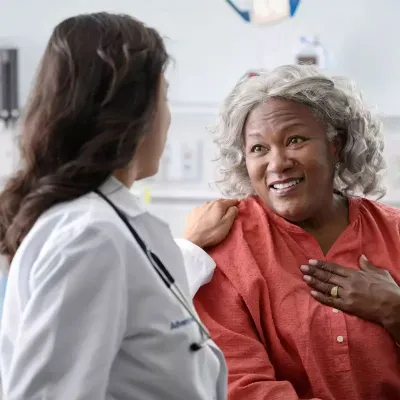 a patient woman talks to a doctor