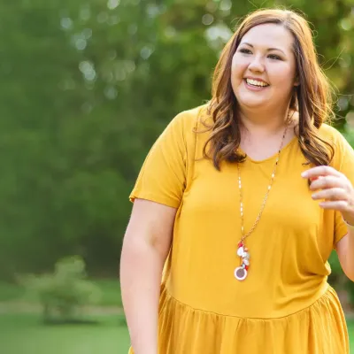 woman outside in yellow dress