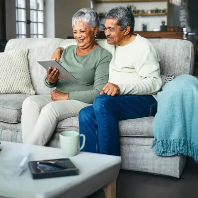hispanic couple sitting in their home