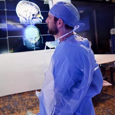 physician-looking-at-brain-scans