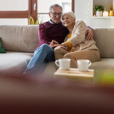 Hero older couple sitting on couch
