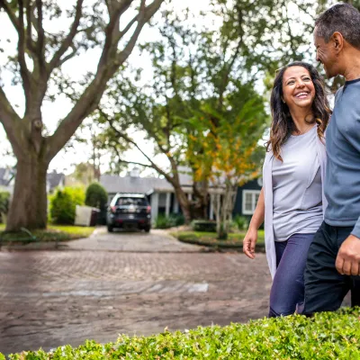 Man and woman walking in neighborhood