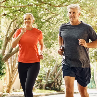 A Couple Jogging Through the Woods