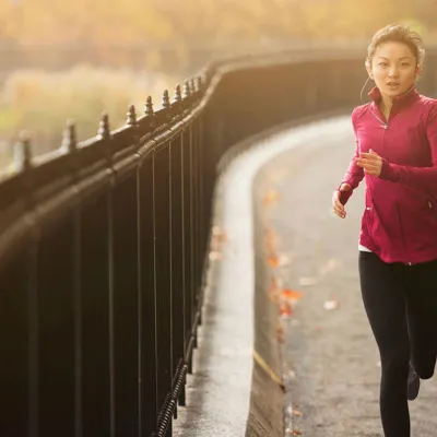 woman running on a path next to a lake