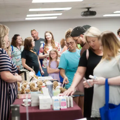People waiting for a table booth at the Maternity Fair