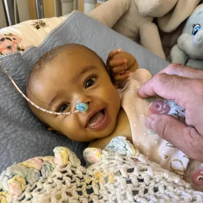 Baby Mattie smiles at the camera.