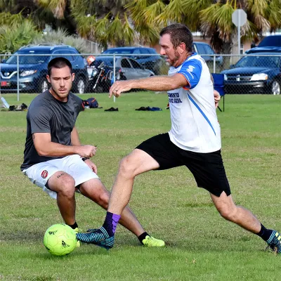 Two men playing soccer on a field