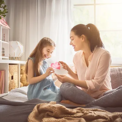 Mother and daughter share a loving card.