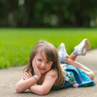 A young girl laying down at a park
