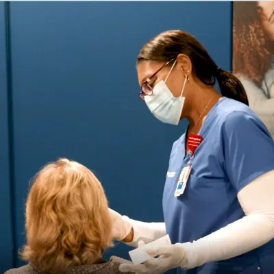 AdventHealth employee administers a COVID19 test to patient