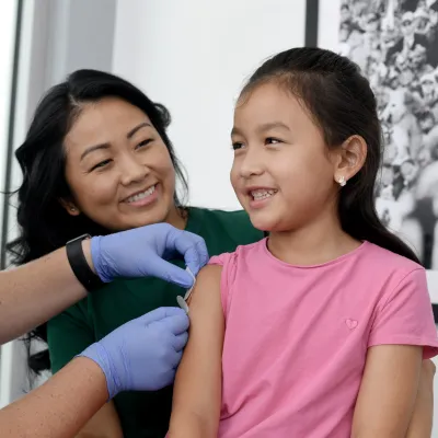 A Nurse Puts a Band Aid on a Child Patient after an Injection