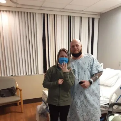 Keith Baon and Stacey Szczudlo posing after she said yes to his proposal during his hospital visittacey Szczudlo.