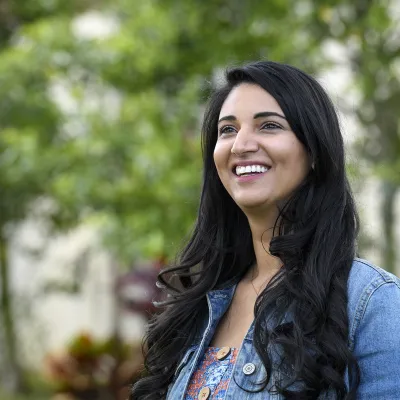 Happy woman looking upward and smiling.