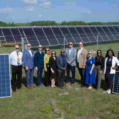 AdventHealth team members help cut the ribbon on OUC solar farm.