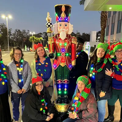 AdventHealth Riverview team members celebrate Lighting the Way, a drive through holiday event supporting ECHO.