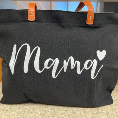A canvas tote with the word mama written on it