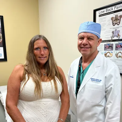 Dr. Federico Vinas and patient Sandi Potter share a moment together, highlighting her successful recovery made possible through exceptional clinical care and the AdventHealth Daytona Beach financial assistance program.