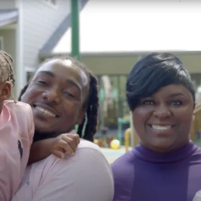 A family of four smiling