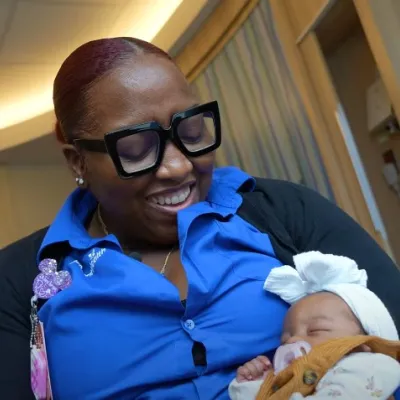 Fourth Trimester care coordinator Erike King holds a baby. 