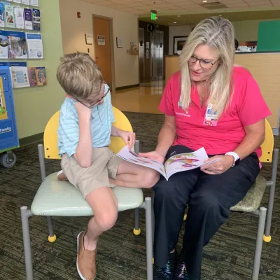 AH staff and child reading  the book