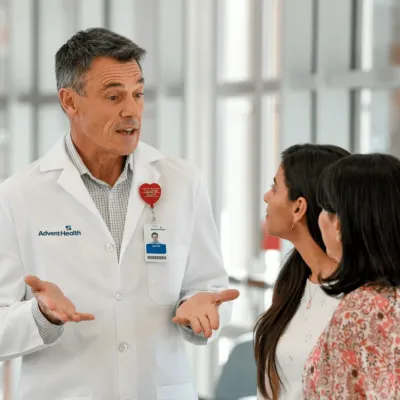 doctor speaking to two female patients
