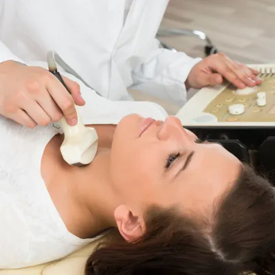 woman getting ultrasound on next