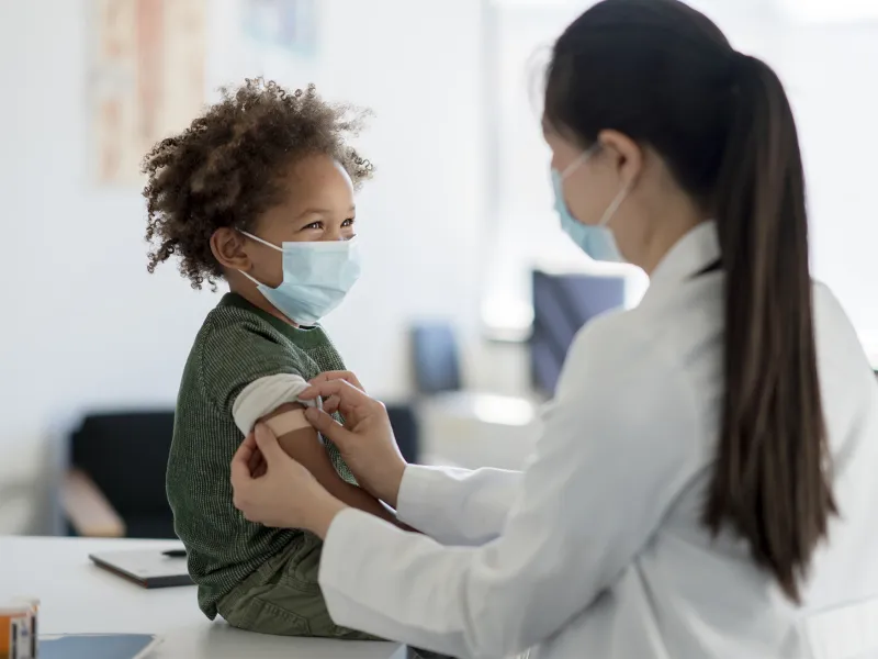 A Pediatrician Checks a Young Boy's Vitals in an Exam Room