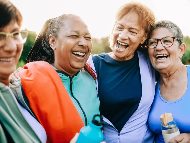 A Group of Senior Women Take a Break From a Run to Share a Laugh