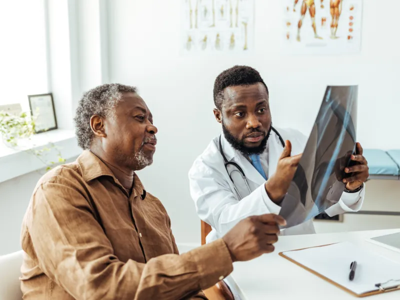 A Doctor Goes Over an X-Ray with a Patient