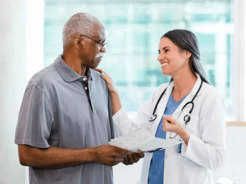 Man with doctor reviewing pamphlet