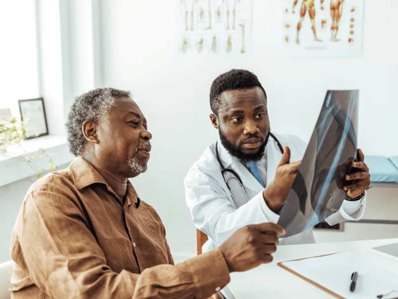 Doctor showing elderly man an X-Ray